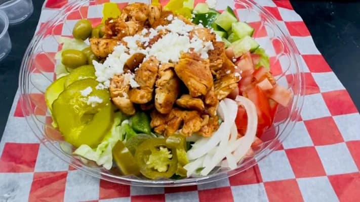 Chicken salad with feta, olives, pickles, tomato and jalapeños