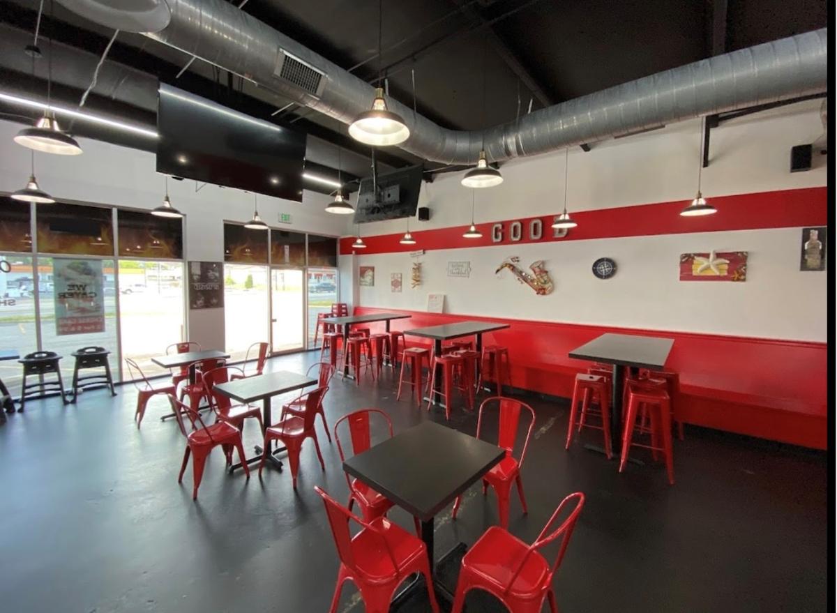 The Chick Fish dining room in Goodlettsville with red chairs, black tables and a red stripe along the wall